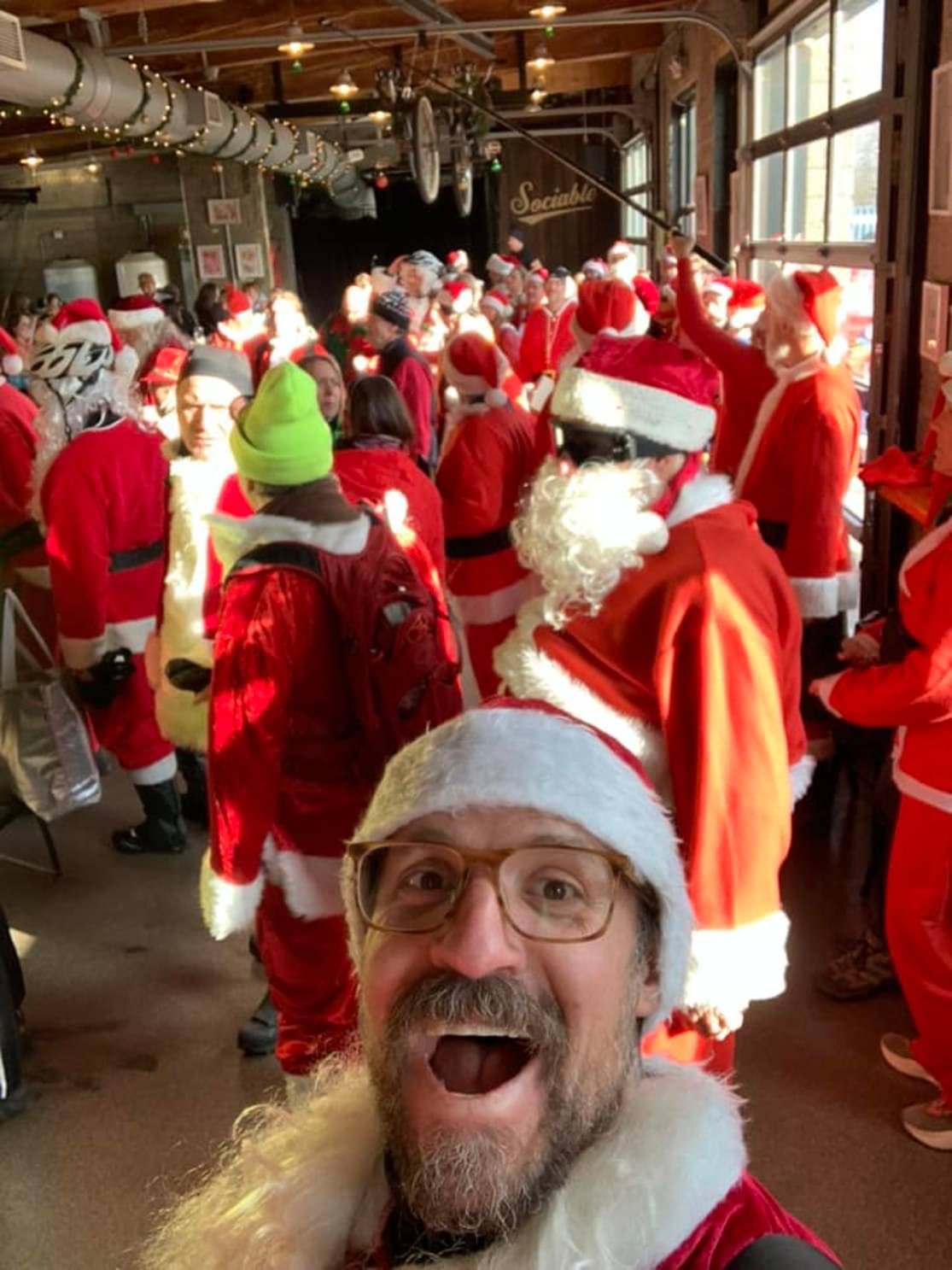 A brewery crowded with Santa-costumed riders