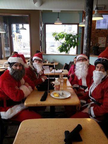 Four of the first Santa riders gathered around a brewery table