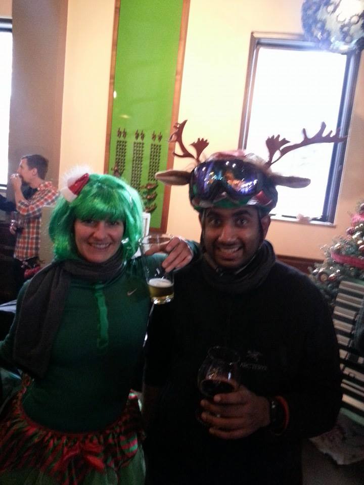 Two early riders in a green wig and reindeer antlers