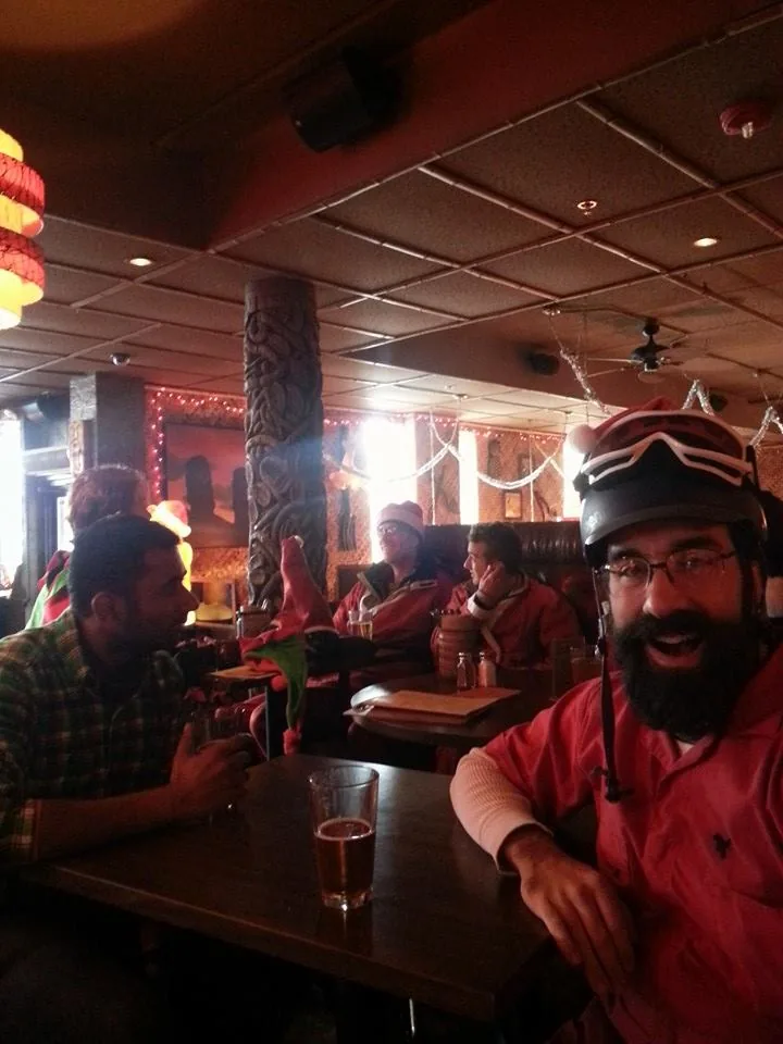 Early Santa riders sharing a moment at a brewery