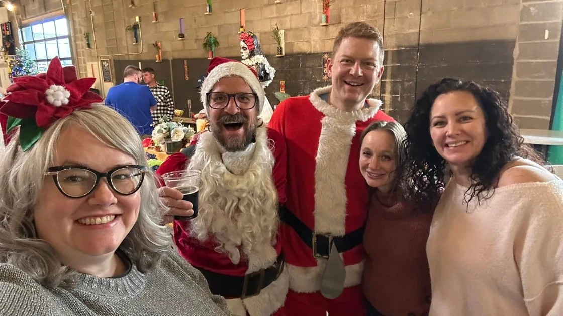 Five friends in Santa costumes at La Doña during the 2024 ride